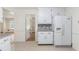 Bright kitchen with white cabinets, tile backsplash, granite counters and tile floors at 1051 Rock Springs Rd, Lawrenceville, GA 30043