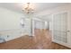 Spacious living room with a chandelier, white trim, wood floors and french doors at 1051 Rock Springs Rd, Lawrenceville, GA 30043