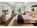 Staged bedroom with hardwood flooring, a trey ceiling, and bright natural light from the window at 819 Bermuda Run, Woodstock, GA 30189