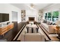 Bright living room features a fireplace, built-in shelving, hardwood flooring, and neutral decor at 819 Bermuda Run, Woodstock, GA 30189