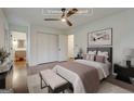 Comfortable staged bedroom featuring hardwood floors, a ceiling fan and ensuite bathroom at 3159 Nursery Se Rd, Smyrna, GA 30082