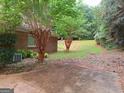 Spacious backyard with a patio and wooded area at 175 Abner Dr, Mcdonough, GA 30252