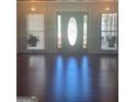 Open foyer area featuring hardwood flooring, and a decorative front door at 3705 Sandhill Se Dr, Conyers, GA 30094