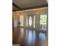 Elegant foyer with hardwood floors, decorative lighting, and large windows at 3705 Sandhill Se Dr, Conyers, GA 30094