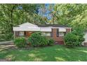 Classic brick home featuring a well-manicured lawn and tasteful landscaping for enhanced curb appeal at 2576 Godfrey Nw Dr, Atlanta, GA 30318