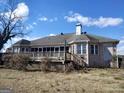 Brick home exterior showing a wooden deck and a partially screened porch with a chimney at 0 Hawkins Academy Rd, Social Circle, GA 30025