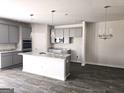 Bright kitchen featuring an island with white countertop and stainless steel appliances at 1613 Fuma Leaf Way # 273, Mcdonough, GA 30253