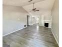 Open-concept living room features a fireplace, and modern flooring at 110 Peridot Pl, South Fulton, GA 30349