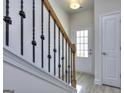 Bright entryway with wood-look flooring, staircase, and white doors at 6116 Ripple Way # 47, South Fulton, GA 30349