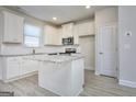 Modern kitchen with white cabinets, stainless steel appliances, and granite countertops at 6116 Ripple Way # 47, South Fulton, GA 30349