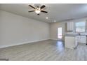 Spacious living room with wood-look flooring and access to the kitchen at 6116 Ripple Way # 47, South Fulton, GA 30349
