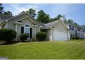 Beautiful one-story home with an attached garage and well-maintained lawn in a friendly neighborhood at 207 Millwheel Dr, Villa Rica, GA 30180