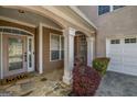 Covered porch with stone floor, white columns, and a charming porch swing at 269 Legends Trce, Mcdonough, GA 30253