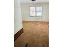 This bedroom features plush carpet and natural light from two windows at 215 Highland Dr, Locust Grove, GA 30248