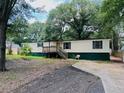 Charming single-story home with wood siding and a front porch at 215 Highland Dr, Locust Grove, GA 30248