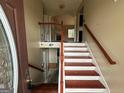 Bright entryway with wood-trimmed stairs leading to the upper level of the home at 3393 Madison Farm Way, Snellville, GA 30039