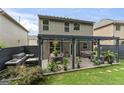 Home backyard features a wooden deck with grill, outdoor dining, and covered furniture and plants at 5768 Grande River Rd, Atlanta, GA 30349
