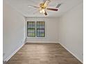 Bedroom featuring laminate flooring, ceiling fan, and a window at 1084 Village Rd, Stone Mountain, GA 30088