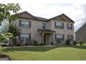 Two-story brick home with landscaped lawn at 1625 Zara Ln, Stockbridge, GA 30281