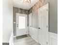 Bright entryway with neutral walls, wood-look floors, and white doors at 4248 Brighton Nw Way, Kennesaw, GA 30144