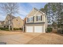 Two-story house with brick and siding exterior, two-car garage, and landscaping at 4248 Brighton Nw Way, Kennesaw, GA 30144