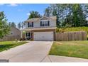 Charming two-story home featuring a two-car garage and a well-manicured lawn at 1018 Nandina Ct, Villa Rica, GA 30180