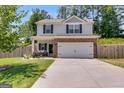 Inviting two-story home featuring brick accents, a two-car garage, and a well-manicured front lawn at 1018 Nandina Ct, Villa Rica, GA 30180