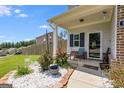 Welcoming front porch with seating area, plants, and decorative touches at 1018 Nandina Ct, Villa Rica, GA 30180