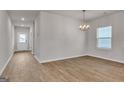 Bright dining area features wood-look floors, natural light, and modern chandelier at 271 Orwell Dr # 49, Social Circle, GA 30025