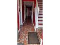 Inviting entryway with red walls, patterned tile floor, and staircase at 5608 Executive Way, Norcross, GA 30071