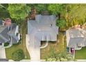 A high aerial perspective displays the home's layout within a lush, tree-filled neighborhood at 3192 Creek W Trce, Powder Springs, GA 30127