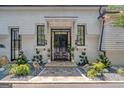 Elegant entryway with a grand black door and a stone pathway at 3946 Paces Ferry Nw Rd, Atlanta, GA 30327