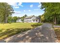 Beautiful two-story home with a long driveway and mature trees surrounding the property at 330 N Fayette Dr, Fayetteville, GA 30214