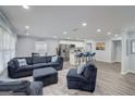 Open-concept living room featuring modern decor, a large sectional sofa, and hardwood floors at 749 Casplan Sw St, Atlanta, GA 30310