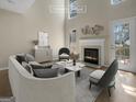 This staged living room features a cozy fireplace and a bright atmosphere with large windows at 9997 Point View Dr, Jonesboro, GA 30238