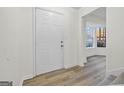 Bright entryway with new flooring, leading to a sunlit sitting area at 1008 King Rd, Riverdale, GA 30296