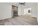 Living room with a stone fireplace and wood-look flooring at 1008 King Rd, Riverdale, GA 30296