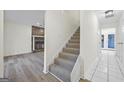 Carpeted staircase with a stone fireplace visible in the background at 1008 King Rd, Riverdale, GA 30296