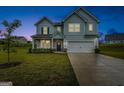 Two-story light blue house with a two-car garage and front yard at dusk at 1168 Bodega Loop, Locust Grove, GA 30248