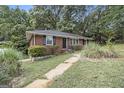 Well-maintained single story brick home with black shutters and a mature lawn at 770 Bridgewater Street Southwest W St, Atlanta, GA 30310