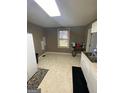 Bright kitchen with white cabinets and tile floors at 215 Sims St, Palmetto, GA 30268