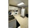 White kitchen with appliances and ample counter space at 215 Sims St, Palmetto, GA 30268