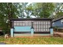 Exterior view of a light blue house with lattice work at 1939 Dunlap Ave, East Point, GA 30344