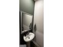 Chic powder room featuring a pedestal sink, modern fixtures, and decorative towels at 253 Ivey Ter # 48, Temple, GA 30179