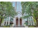 Building entrance featuring large doors, manicured landscaping, and a welcoming stairway at 2870 Pharr Court South Nw Ct # 2703, Atlanta, GA 30305