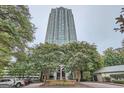 High-rise building exterior showing the unique architecture and beautifully landscaped grounds and circular driveway at 2870 Pharr Court South Nw Ct # 2703, Atlanta, GA 30305