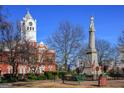 Historic courthouse with a clock tower and a war memorial statue on a sunny day at 172 Weldon Rd # 19, Mcdonough, GA 30253