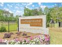 Attractive entrance to Campground Crossing community with colorful flowers and a glimpse of the playground at 180 Weldon Rd # 21, Mcdonough, GA 30253