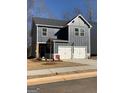 A two-story home features a gray exterior, white trim, a two-car garage, and a modern design at 180 Weldon Rd # 21, Mcdonough, GA 30253