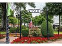 Scenic McDonough town square with lush greenery, vibrant flowers, and patriotic American flag at 180 Weldon Rd # 21, Mcdonough, GA 30253